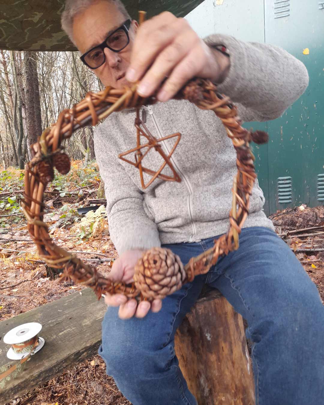 The Woodland project parent day holding a woven wreath with a star